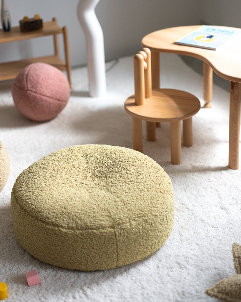 Wigiwama Teddy-Stoffballkissen Guave in een kinderkamer
